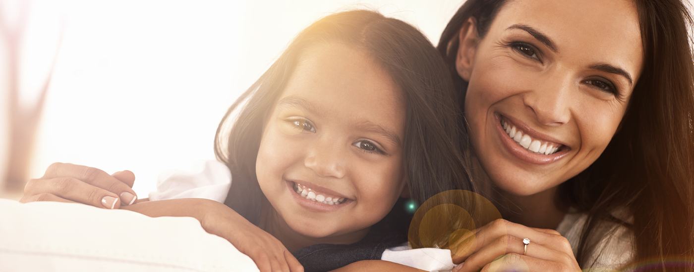 Smiling mother and daughter after children's tongue tie treatment