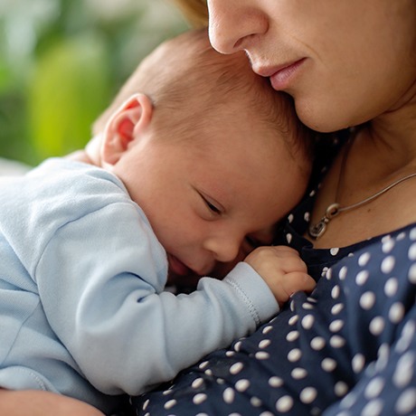 Mother holding sleeping baby