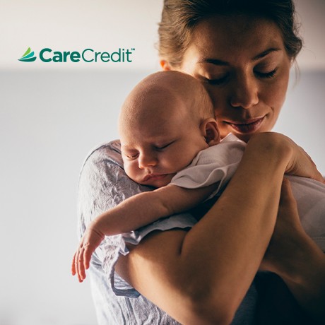 Mother holding sleeping baby