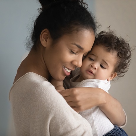 Mother hugging baby after myofunctional therapy