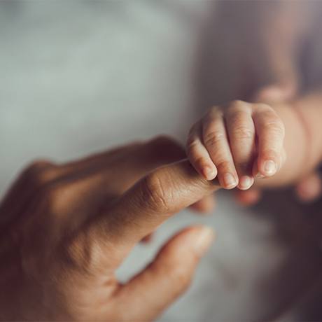 Child holding mother's hand after posterior tongue tie treatment