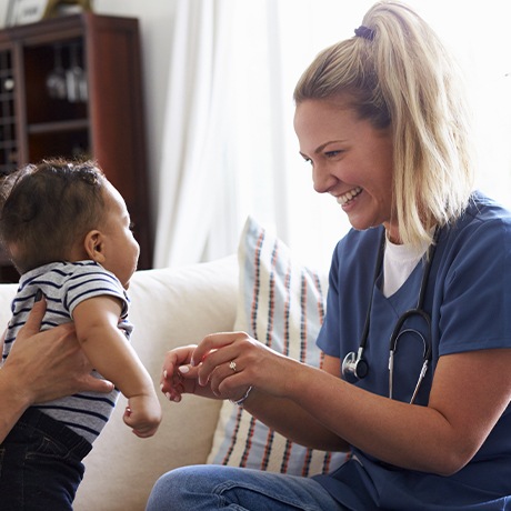 Dental team member smiling at baby