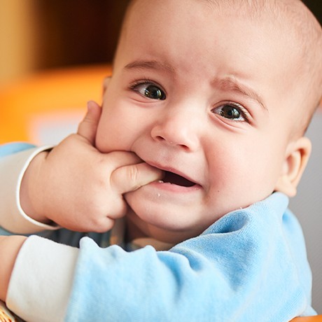 Baby in need of lip and tongue tie treatment crying