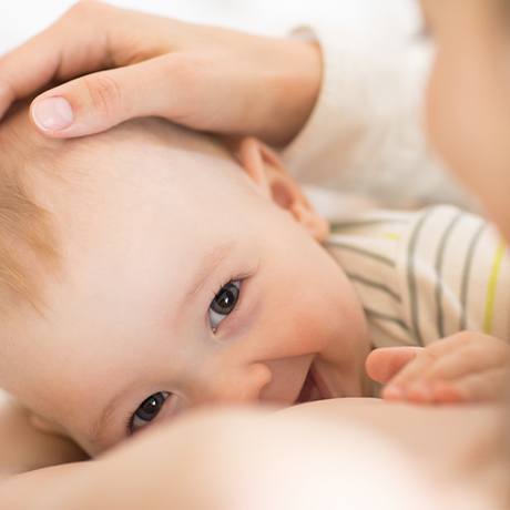 Baby smiling at mother