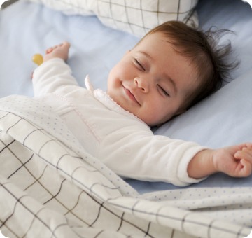Baby sleeping with a smile