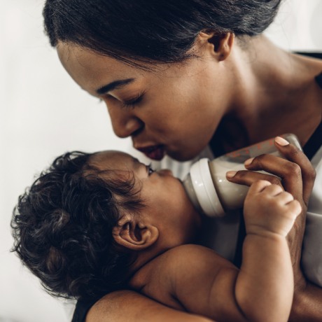 Mother bottle feeding her baby