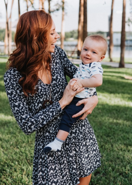 Doctor Davis smiling and holding her baby