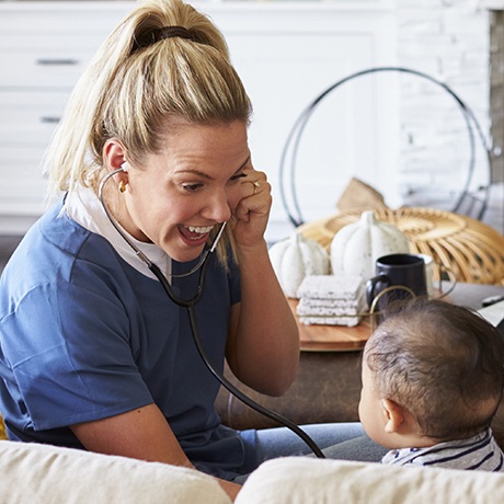 Tongue tie specialist laughing with baby