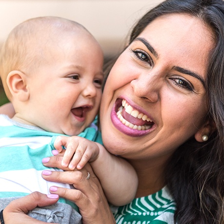 Laughing mother and baby after lip and tongue tie