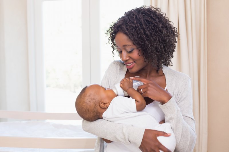 a mother bottle-feeding her baby