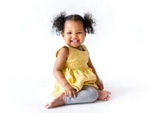 Portrait of smiling little girl in yellow top
