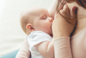 a closeup of child breastfeeding 
