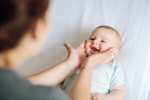 mother holding a baby’s face